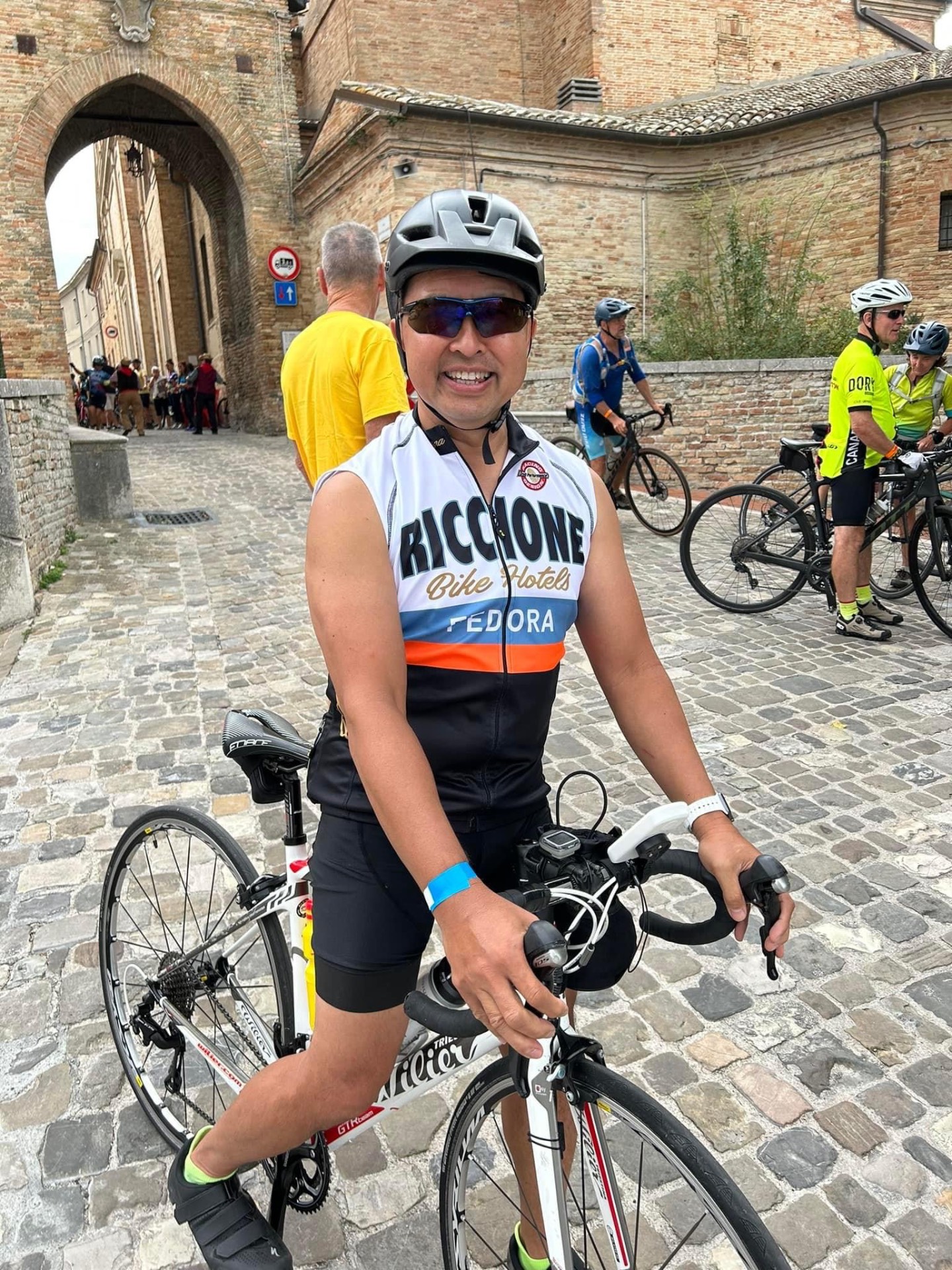 Eric cycling through a historic Italian town, 2023