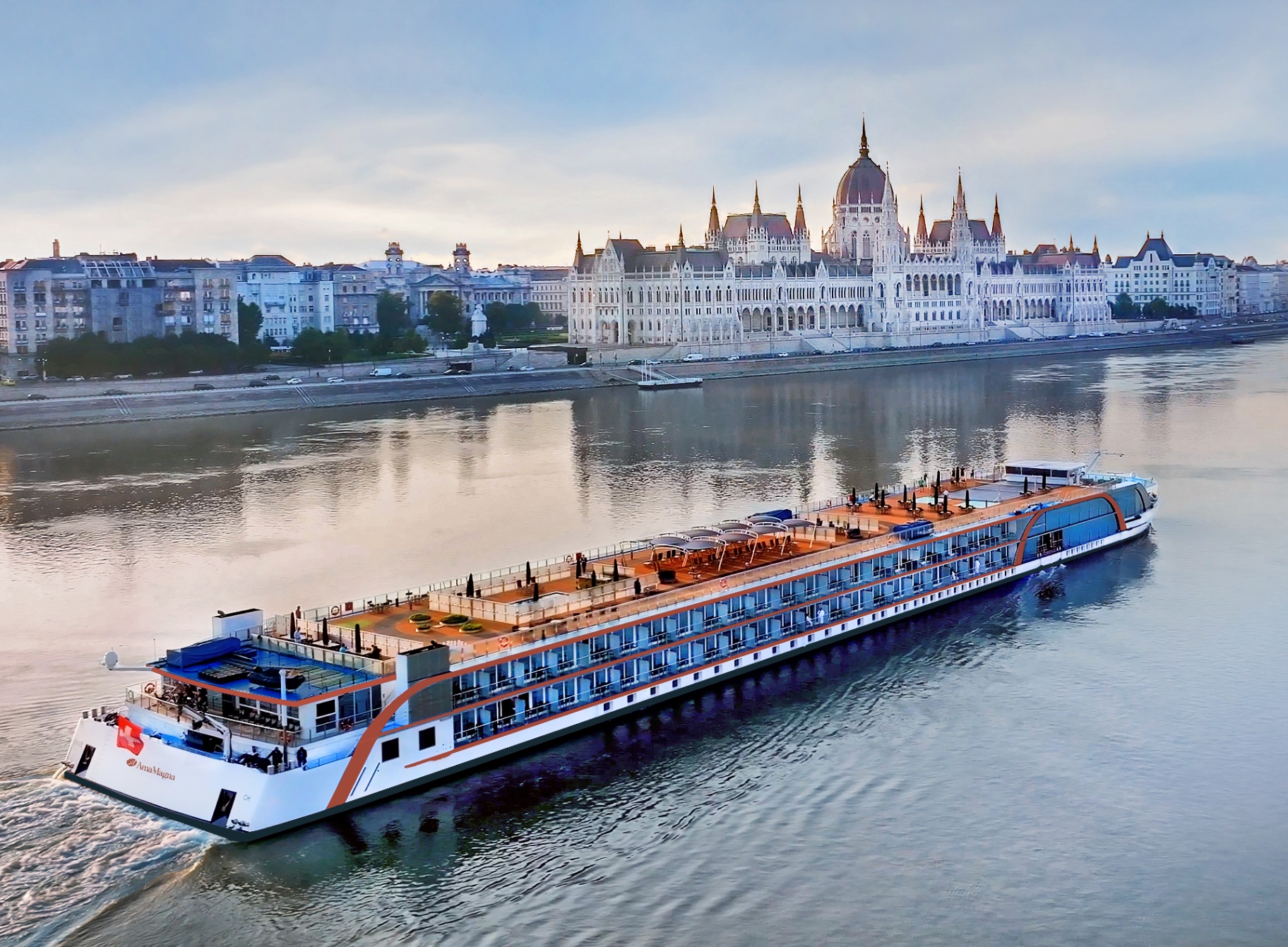 The Danube at dusk in Budapest, the illuminated parliament reflected on the water.